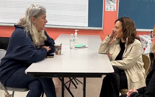 Photo of Kamala Harris speaking with a Red Cross first responder